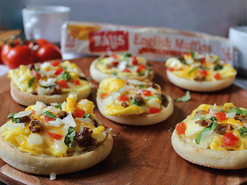 a tray of bays topped with chunks of egg pepper and sausage