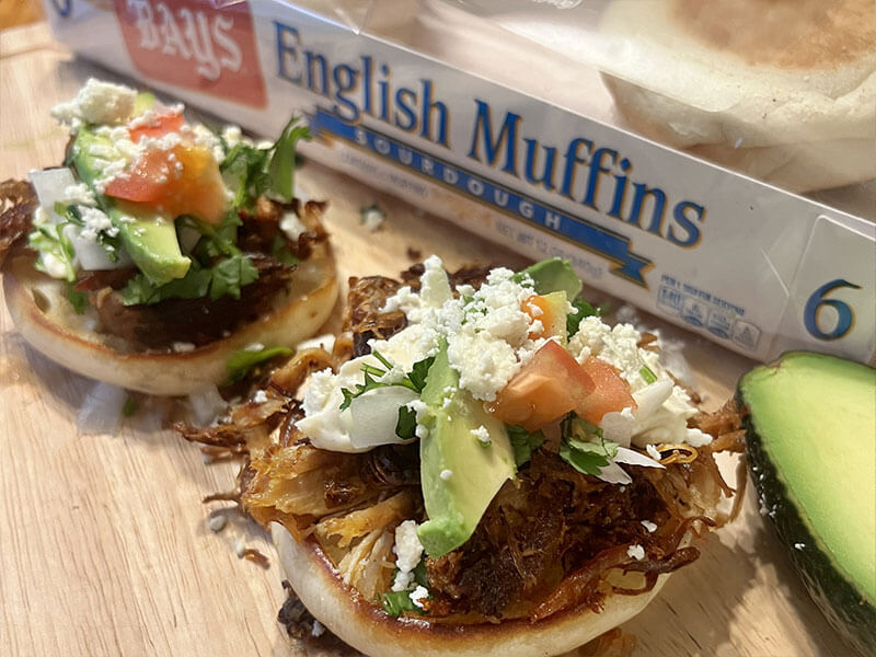 bays with meat avocado slices and crumbly cheese on top