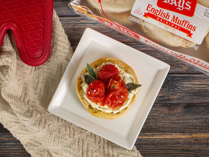 bays topped with white cream, red fruit and basil