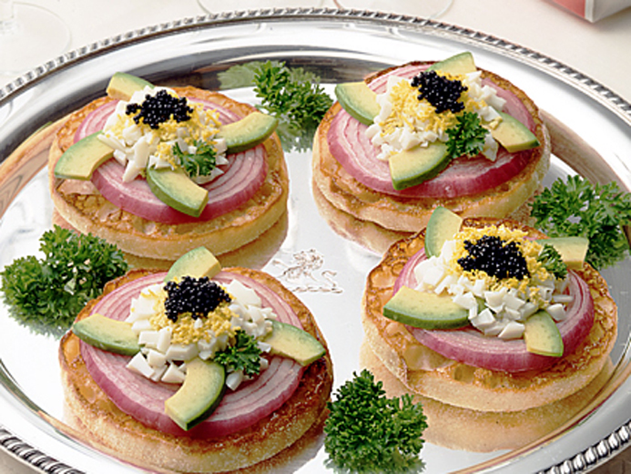 FOUR BAYS ENGLISH MUFFINS TOPPED WITH PERFECT ONION RINGS, AVOCADO IN A SPIRAL PATTERN AND A DALLOP OF CAVIAR