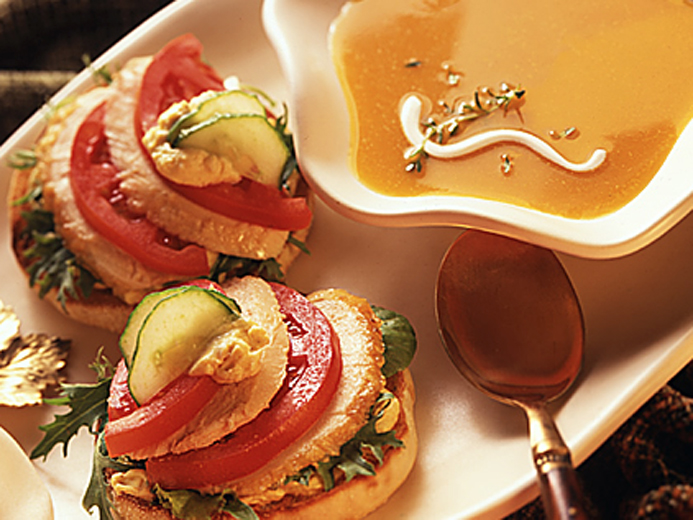 ORANGE SOUP AND BAYS STACKED WITH MEAT AND VEGGIES