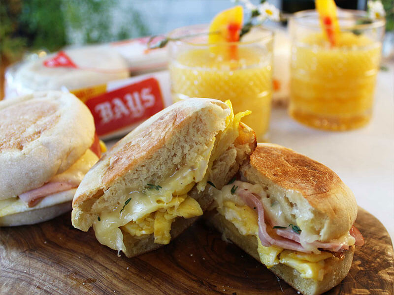 bays with meat cheese, and yellow drinks in the background